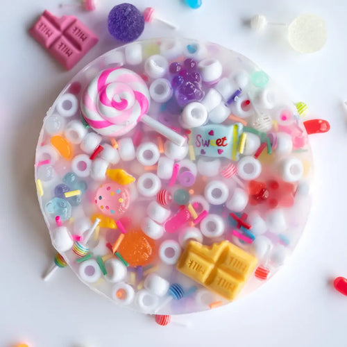 Candy World Picking Pad – overhead view showing colorful candy charms in a clear squishy circular pad
